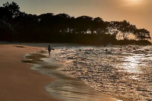 a group of people on a beach near a body of water